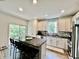 Modern kitchen with stainless appliances, breakfast bar, and access to outdoor balcony at 6927 Havenmoor Pl, Indianapolis, IN 46250