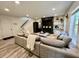 Inviting living room with a cozy sectional, TV, fireplace, and built-in shelves at 6927 Havenmoor Pl, Indianapolis, IN 46250