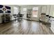 Bright and airy living room featuring hardwood floors, large windows, and contemporary furnishings at 6927 Havenmoor Pl, Indianapolis, IN 46250