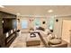 Spacious living room featuring a modern fireplace, large sectional sofa and wood-look floors at 6927 Havenmoor Pl, Indianapolis, IN 46250