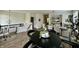 Open-concept living area with hardwood floors, a dining table, and a comfortable seating area at 6927 Havenmoor Pl, Indianapolis, IN 46250