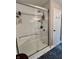 Bright bathroom with a frameless shower including a built-in bench and shelving niche at 6927 Havenmoor Pl, Indianapolis, IN 46250