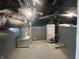 Unfinished basement with gray brick walls featuring an HVAC system and water heater at 706 N Euclid Ave, Indianapolis, IN 46201