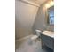 Bathroom showcasing an angled ceiling, modern vanity, and updated toilet at 706 N Euclid Ave, Indianapolis, IN 46201