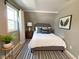 A well-lit room featuring a comfortable bed, stylish accents, and ample natural light at 706 N Euclid Ave, Indianapolis, IN 46201