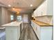 The open concept kitchen features a center island, stainless steel appliances, and pendant lighting at 706 N Euclid Ave, Indianapolis, IN 46201