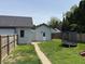 Backyard featuring detached garage, trampoline, and plenty of green space for outdoor activities at 707 S Harrison St, Alexandria, IN 46001