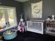 Bedroom featuring large bay window, plush black rug, and whimsical decor at 707 S Harrison St, Alexandria, IN 46001