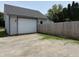 Detached two-car garage with gravel driveway and fenced perimeter for added privacy at 707 S Harrison St, Alexandria, IN 46001