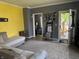 Cozy living room with neutral tones, large window and open doorway to the porch at 707 S Harrison St, Alexandria, IN 46001