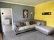Spacious living room featuring corner sofa and colorful accent wall, perfect for relaxation at 707 S Harrison St, Alexandria, IN 46001