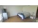Cozy bedroom featuring wood-look flooring, dresser, and neutral paint at 713 Driftwood Cir, Danville, IN 46122