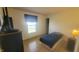 Bedroom featuring a bed, TV, and wood-look flooring at 713 Driftwood Cir, Danville, IN 46122