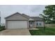 Charming single-story home featuring a two-car garage and a well-maintained front yard at 713 Driftwood Cir, Danville, IN 46122
