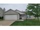Inviting single-story home with a two-car garage, landscaped front yard, and a welcoming entrance at 713 Driftwood Cir, Danville, IN 46122