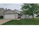Inviting single-story home with a two-car garage, landscaped front yard, and a welcoming entrance at 713 Driftwood Cir, Danville, IN 46122