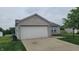 Home featuring a two-car garage, complementing the well-maintained landscaping at 713 Driftwood Cir, Danville, IN 46122