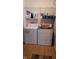 Well-equipped laundry room with a washer and dryer under a wire shelf for storage at 713 Driftwood Cir, Danville, IN 46122