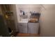 Functional laundry area with white washer and dryer, plus shelving for organized storage at 713 Driftwood Cir, Danville, IN 46122