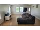 Spacious living room with large windows, wood-look flooring and modern fixtures at 713 Driftwood Cir, Danville, IN 46122
