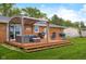 Spacious backyard with wooden deck, comfortable seating, pergola, grill, and lush green lawn at 762 N Dellasburg Rd, Columbus, IN 47203