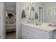 Bright bathroom featuring a white vanity, neutral walls, and decorative touches, seen from the doorway to the main bedroom at 762 N Dellasburg Rd, Columbus, IN 47203