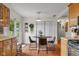 Inviting dining area with a round table, sliding glass doors, and built-in cabinets at 762 N Dellasburg Rd, Columbus, IN 47203