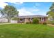 Charming one-story brick home with well-maintained lawn, a front porch, and attached garage at 762 N Dellasburg Rd, Columbus, IN 47203