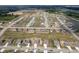 Aerial view of a new construction neighborhood with houses, streets, and a pond at 7834 Fairwood Blvd, Plainfield, IN 46168