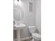 This bathroom has a pedestal sink, oval mirror, toilet, and decor at 7834 Fairwood Blvd, Plainfield, IN 46168