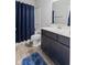 Bathroom with vanity, stylish fixtures, bath tub, and a blue shower curtain at 7834 Fairwood Blvd, Plainfield, IN 46168