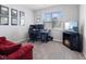 Comfortable bedroom with a workstation, decorative fireplace, and a large window providing natural light at 7834 Fairwood Blvd, Plainfield, IN 46168