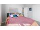 Comfortable bedroom featuring a large bed with stylish accents and a door leading to the hallway at 7834 Fairwood Blvd, Plainfield, IN 46168