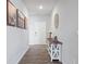 Inviting entryway featuring wood-look floors, stylish console table with decor, and attractive wall art at 7834 Fairwood Blvd, Plainfield, IN 46168