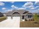 Beautiful brick home featuring a three-car garage, landscaped yard, and a charming covered porch at 7834 Fairwood Blvd, Plainfield, IN 46168