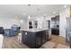 Open kitchen with island and stainless steel dishwasher overlooks the adjacent living area at 7834 Fairwood Blvd, Plainfield, IN 46168