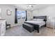 Serene main bedroom featuring a ceiling fan, soft carpet, and a window providing natural light at 7834 Fairwood Blvd, Plainfield, IN 46168