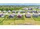 Attractive aerial of neighborhood featuring modern homes with green lawns and nearby pond at 8044 Yarmouth Way, Indianapolis, IN 46239