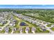 An aerial view showcasing houses near winding streets and well-kept ponds and lush trees at 8044 Yarmouth Way, Indianapolis, IN 46239