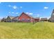 Spacious fenced backyard showcasing lush green grass and the home's rear facade at 8044 Yarmouth Way, Indianapolis, IN 46239