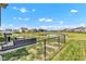 Expansive backyard with well-maintained lawn, a pond, grill, and patio seating at 8044 Yarmouth Way, Indianapolis, IN 46239