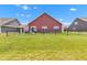 Large fenced backyard with green grass, patio furniture and exterior view of home at 8044 Yarmouth Way, Indianapolis, IN 46239