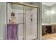 Bright bathroom featuring a glass shower with built-in shelving and a vanity with ample storage at 8044 Yarmouth Way, Indianapolis, IN 46239