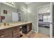 Bathroom with double sink vanity, large mirror, and access to the bedroom at 8044 Yarmouth Way, Indianapolis, IN 46239
