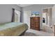 Cozy bedroom features a mounted TV on a dresser and a comfortable bed by a window at 8044 Yarmouth Way, Indianapolis, IN 46239