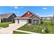A two-car garage home boasting brick accents, manicured lawn, and a smooth concrete driveway at 8044 Yarmouth Way, Indianapolis, IN 46239