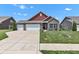 Charming single-Gathering home with a brick facade, three-car garage and well-manicured lawn at 8044 Yarmouth Way, Indianapolis, IN 46239