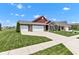 Beautiful single-Gathering home with brick accents, three-car garage, and a lush green lawn at 8044 Yarmouth Way, Indianapolis, IN 46239