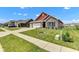 Inviting single-Gathering home with a well-kept lawn, brick accents, and convenient three-car garage at 8044 Yarmouth Way, Indianapolis, IN 46239