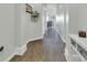 Hallway with hard surface floors and light grey paint leading to an open floor plan at 8044 Yarmouth Way, Indianapolis, IN 46239